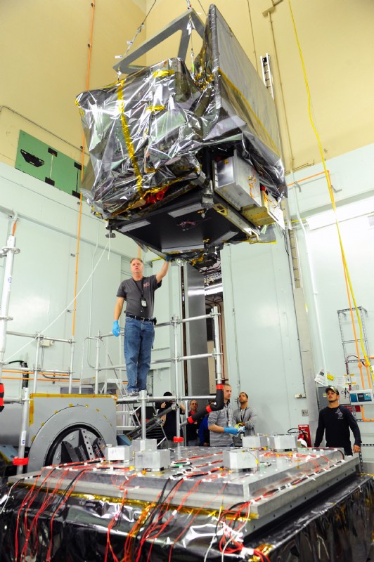 ICESat-2 satellite being lowered onto an Unholtz-Dickie shaker for vibration testing at NASA Goddard