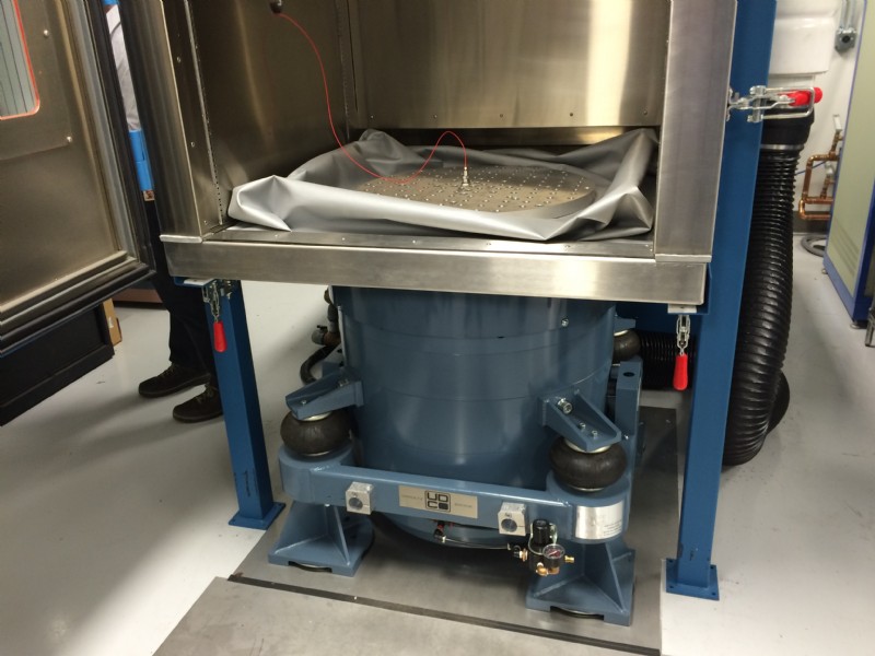 A low profile shaker connected to a temperature chamber enables Environmental Stress Screening with simultaneous vibration/shock and temperature testing